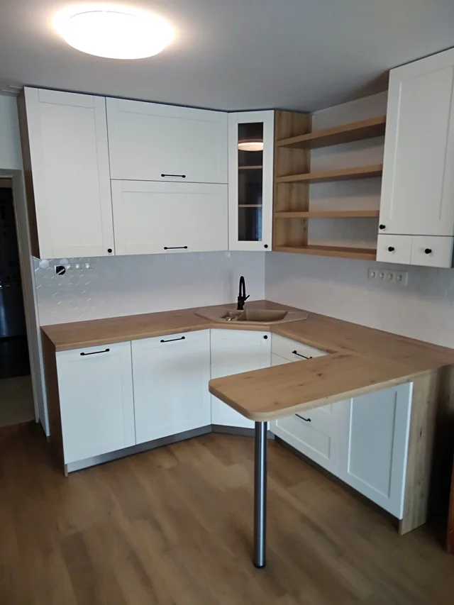 Kuchyň s rámečkovými dvířky, dřevěnou deskou a poloostrůvkem